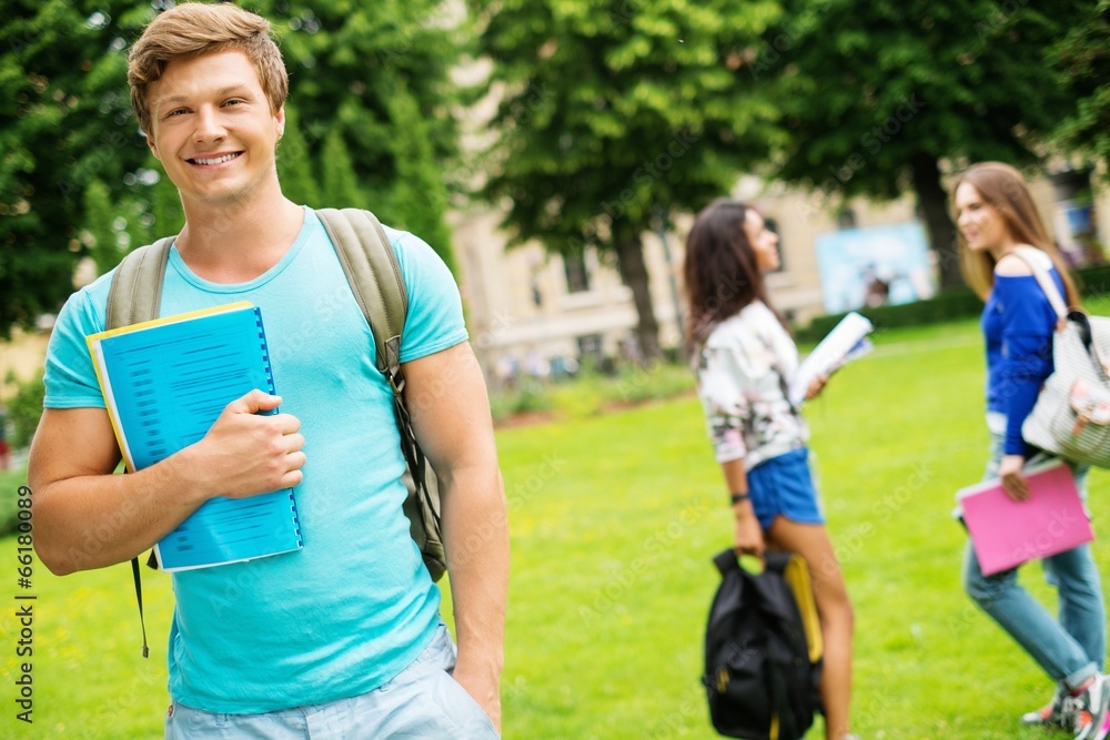Handsome man student in a city park on summer day Handsome man student in a city park on summer day