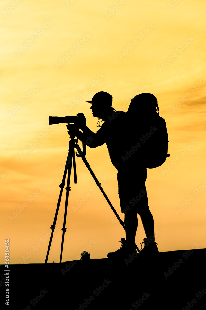 Silhouette of photographer shooting for a sunrise
