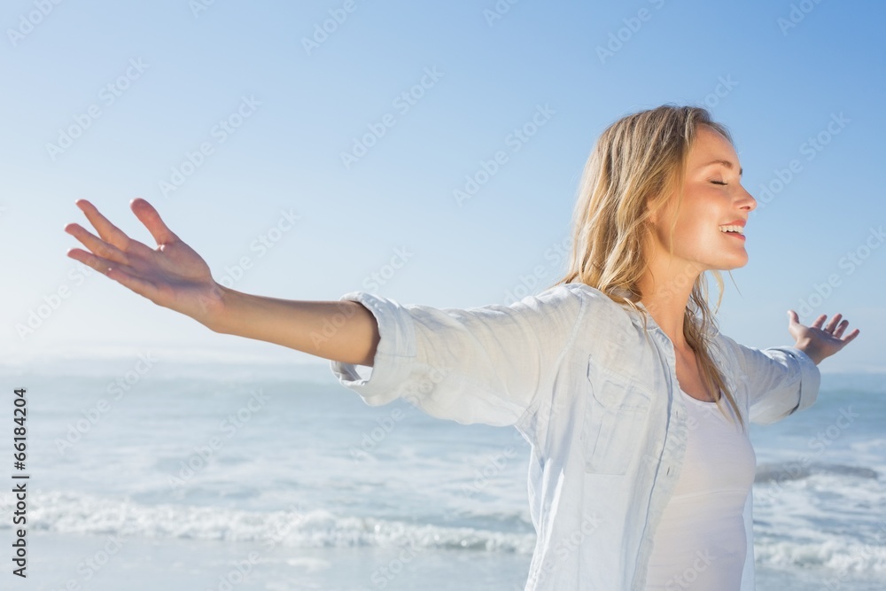 Gorgeous blonde spreading arms out at the beach Gorgeous blonde spreading arms out at the beach