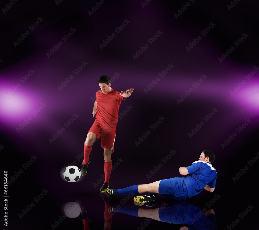 Naklejka premium Football players tackling for the ball