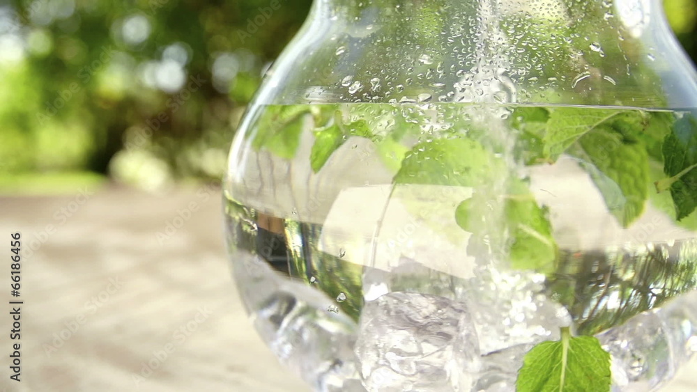 Jug of water with fresh mint leaves, Slow Motion Jug of water with fresh mint leaves, Slow Motion