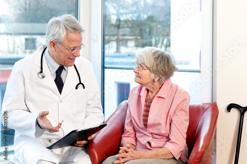 Male doctor in consultation with a senior patient.