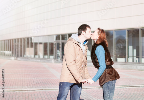 Young couple kissing in autumn city