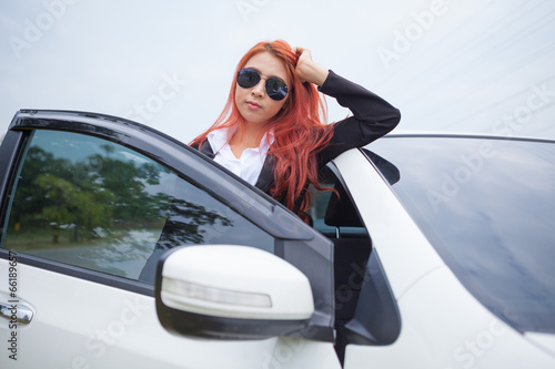 Young businesswoman with car