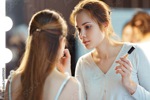 Make-up artist applying consealer photo