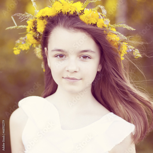 Happy little girl standing in the park. photo