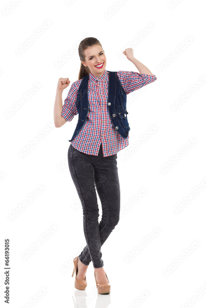Smiling young woman celebrating success Smiling young woman celebrating success
