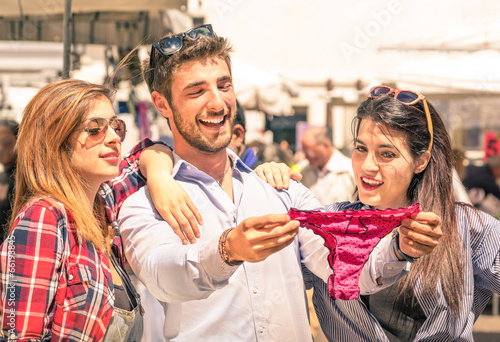 Group of happy young people at the weekly clothes market