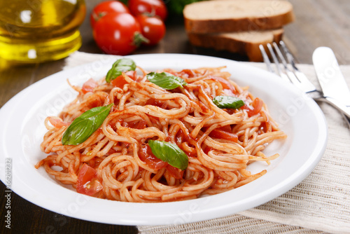 Pasta with tomato sauce on plate on table close-up