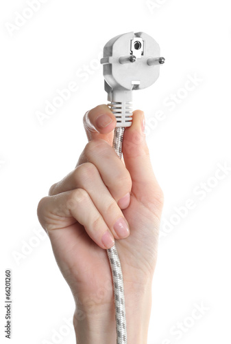 Hand holding electric plug isolated on white
