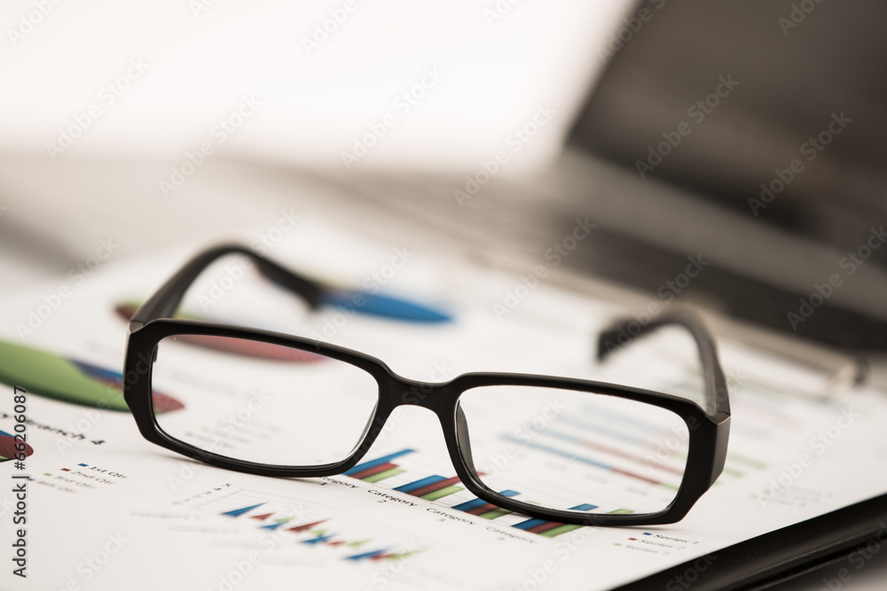 Businessman analyzing investment charts with laptop