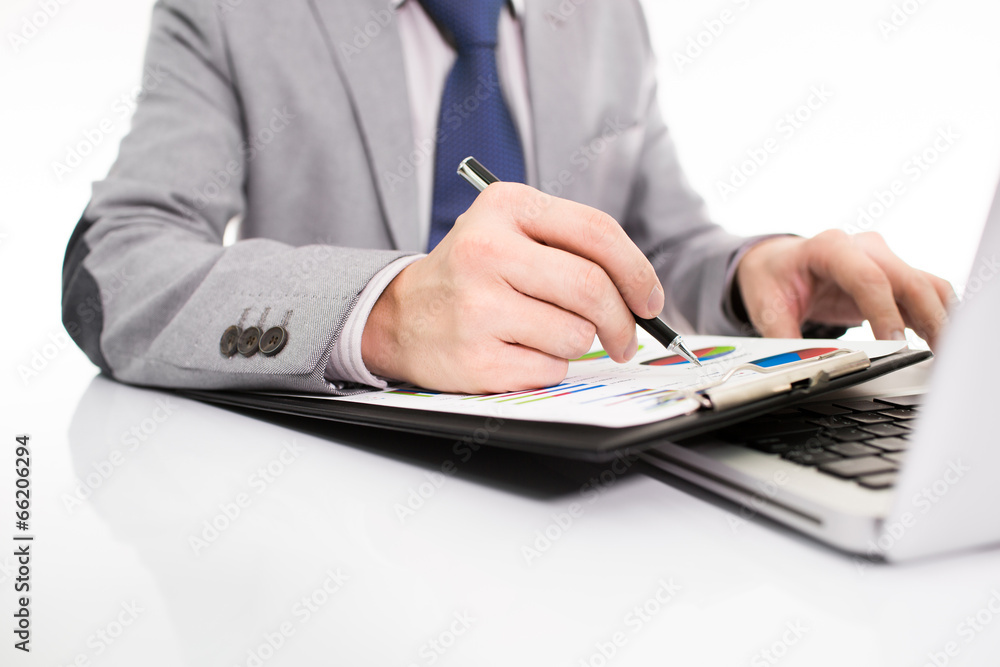 Businessman analyzing investment charts with laptop Businessman analyzing investment charts with laptop