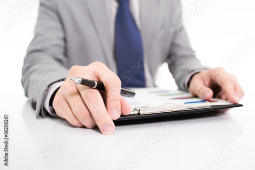Businessman analyzing investment charts with laptop