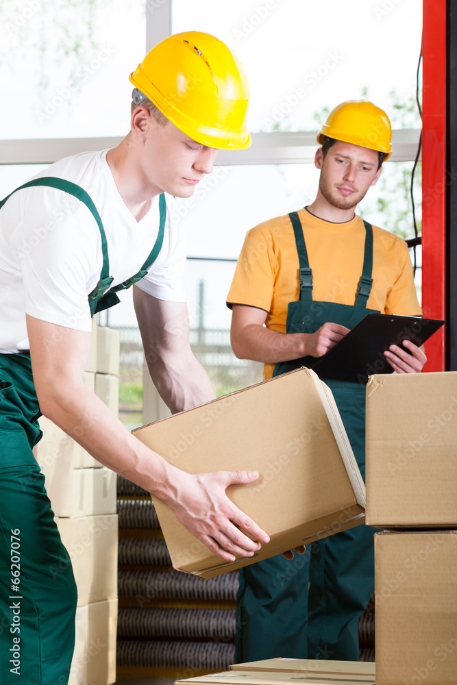 Supervisor and warehouse worker during job Supervisor and warehouse worker during job