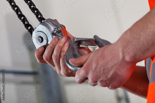 Close-up of male hands and lifting hook