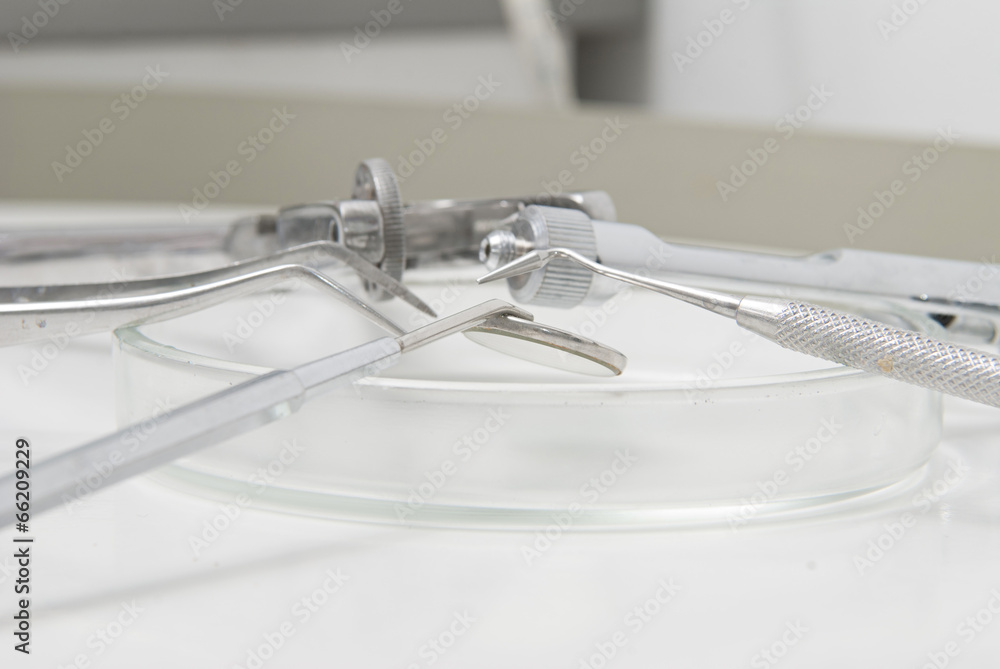 Metallic dentist tools close up in a dentist clinic. Metallic dentist tools close up in a dentist clinic.