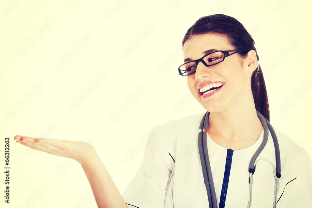 Female doctor showing on copy space. Female doctor showing on copy space.