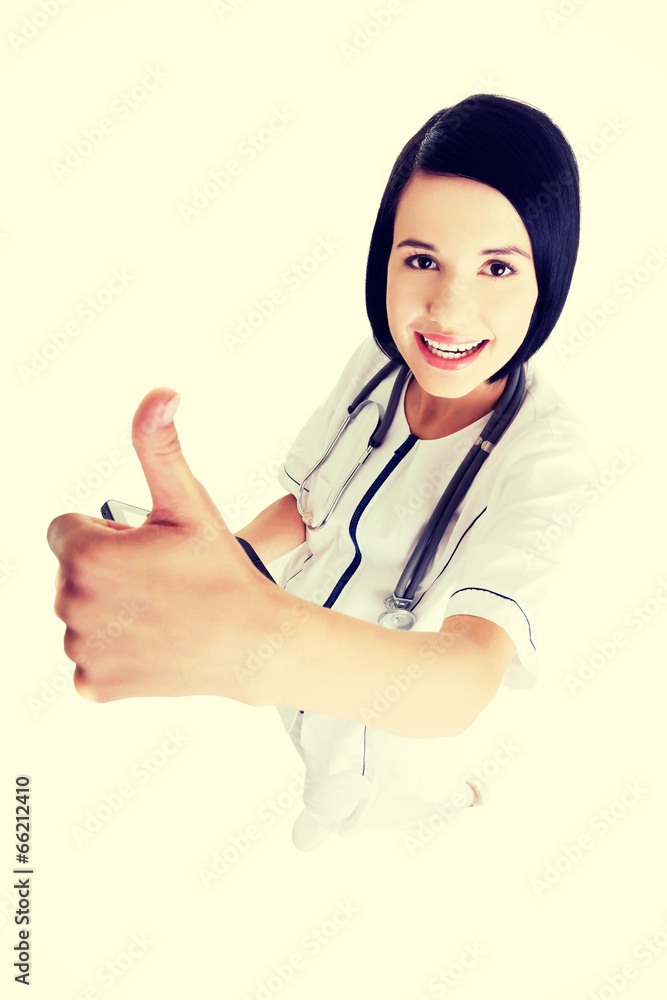 Young female doctor or nurse gesturing OK Young female doctor or nurse gesturing OK