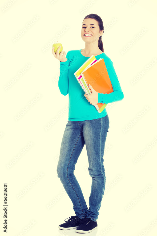 Beautiful young student with files and apple. Beautiful young student with files and apple.