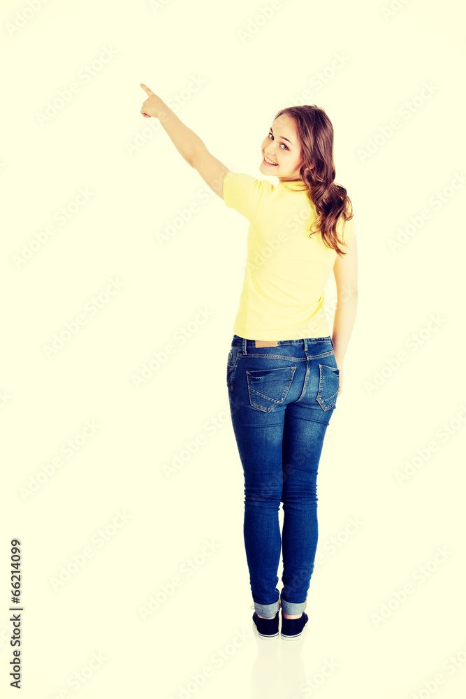 Happy , excited young woman pointing on copy space Happy , excited young woman pointing on copy space