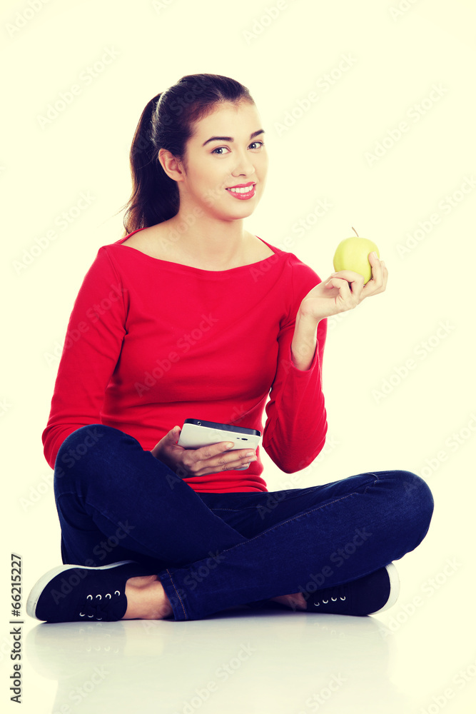 Woman with apple and tablet computer. Woman with apple and tablet computer.