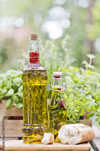 herbs in olive oil bottles
