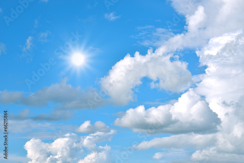 blue sky background with tiny clouds and sun
