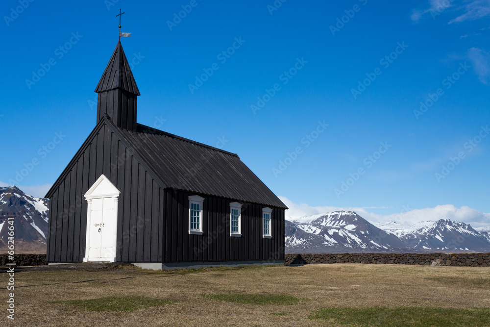 Black Wooden church and mountains
