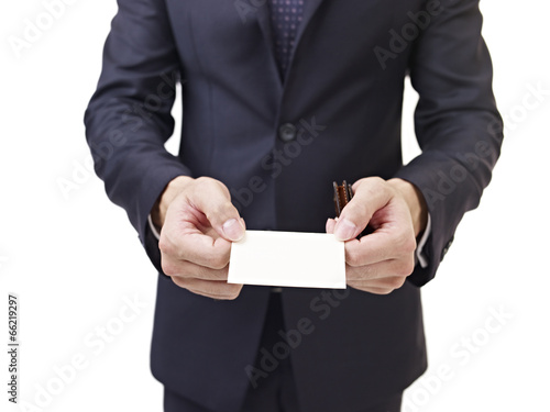 asian businessman holding business card, isolated on white