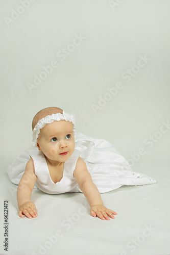 Cute little girl in a white dress.