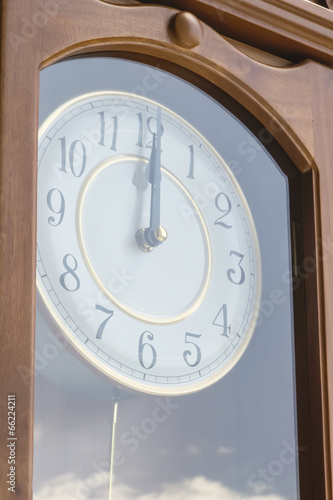 Antique clock with reflection of sky