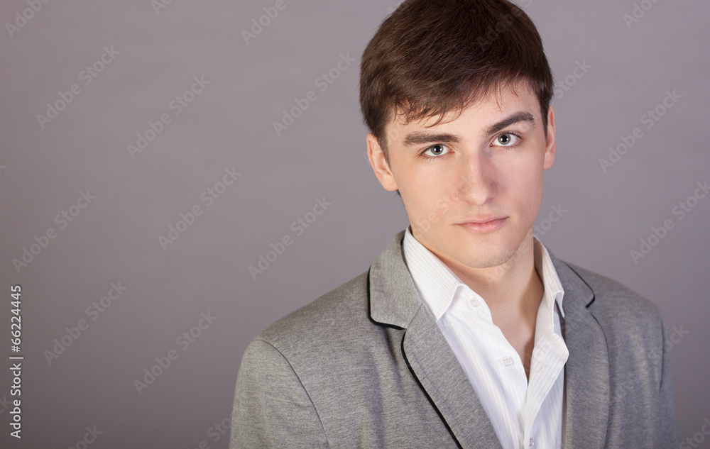 Stylish young businessman on a gray background Stylish young businessman on a gray background