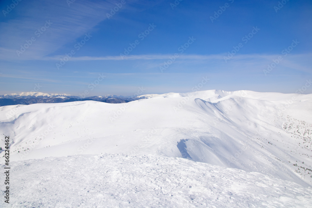WInter snowy mountains landscape with blue sky