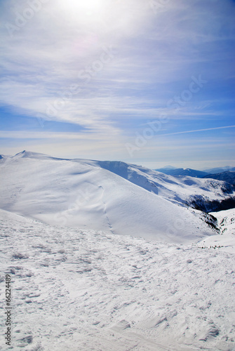 WInter snowy mountains landscape with blue sky © EMrpize