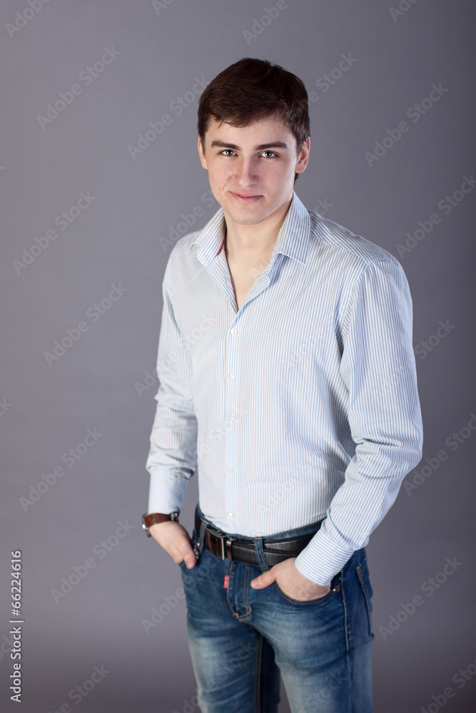 Stylish young businessman on a gray background Stylish young businessman on a gray background