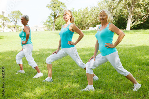 Mature womens doing flexibility exercises