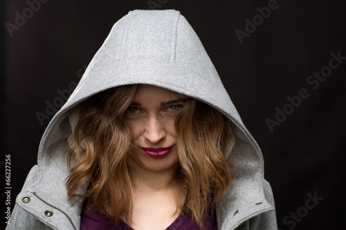 Photography Coy or shy young woman wearing a hood