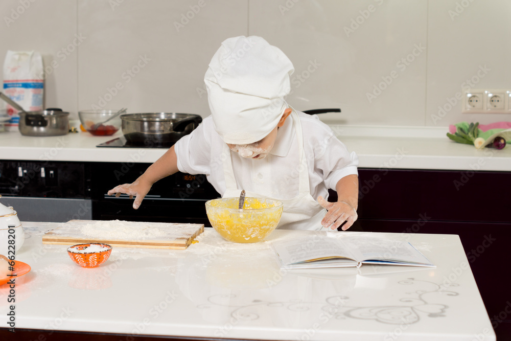 Excited young chef leaning over mixing bowl Excited young chef leaning over mixing bowl