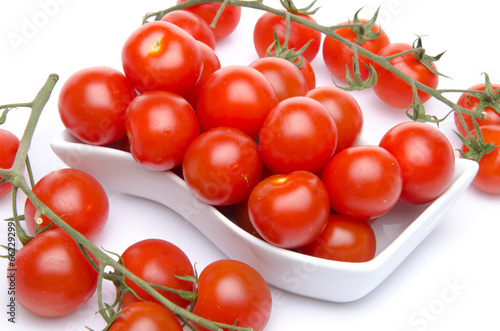 Tomatoes in a white cut and cherry tomatoes