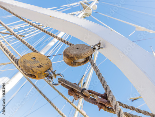 Wooden pulley and ropes on old yacht. View from below.