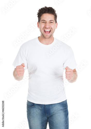 Excited Young Man With Clenching Fists