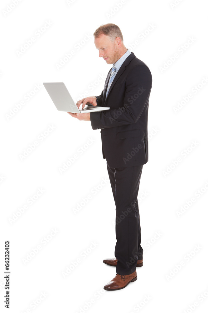Confident Businessman Holding Laptop Over White Background Confident Businessman Holding Laptop Over White Background