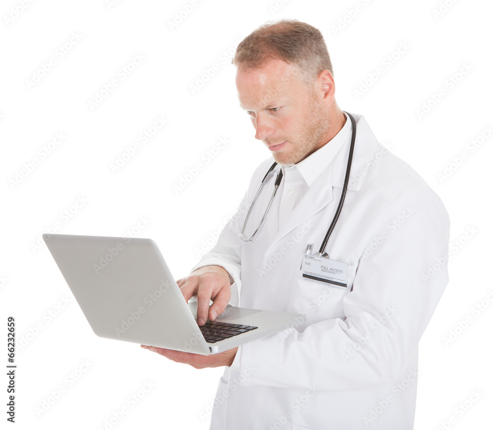 Doctor Using Laptop Over White Background Doctor Using Laptop Over White Background