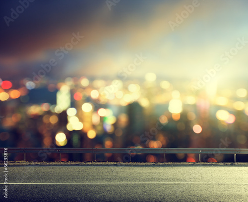 Asphalt road and blurred modern city