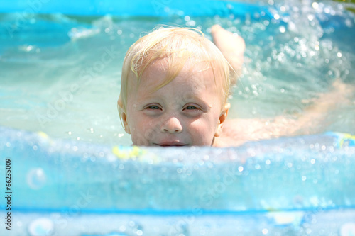Happy Baby Playing in Swimming Pool