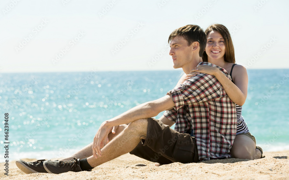 Joyful couple on sunny beach