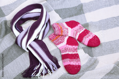 Winter scarf and socks, on color background