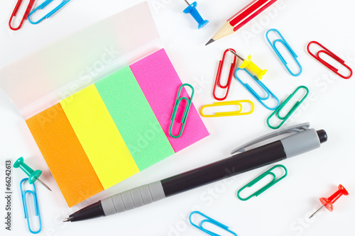 Pen, pencil, paperclips, pushpins and multicolored stickers