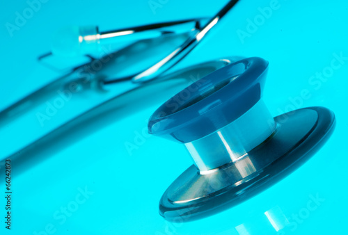 Stethoscope on blue  reflective background