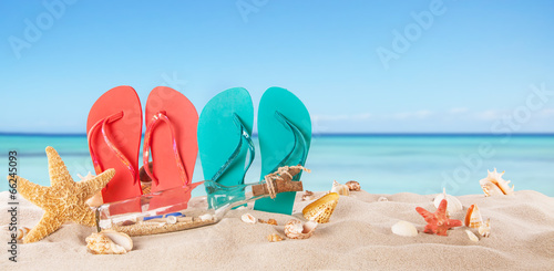 Fototapeta Naklejka Na Ścianę i Meble -  Summer beach with colored sandals